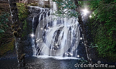 Waterfall with fairy sparks of shimmering light Stock Photo