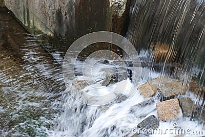 Waterfall on the gray stones full of blurred splashes Stock Photo