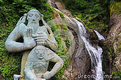 Waterfall and monument of St. Andrew near Sarpi town in Adjara, Georgia Stock Photo