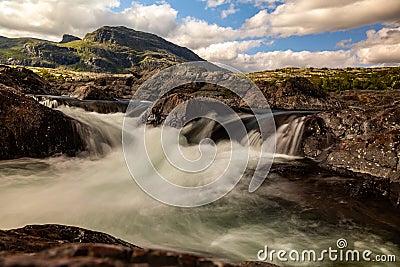 The waterfall in the national park Stora SjÃ¶fallet in Sweden. This is made near the Storasjofallet Mountain lodge. Made in the Stock Photo