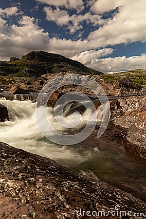 The waterfall in the national park Stora SjÃ¶fallet in Sweden. This is made near the Storasjofallet Mountain lodge. Made in the Stock Photo