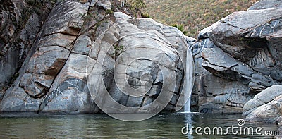 Waterfall and natural swimming pool at Cascada Sol Del Mayo on the Baja California peninsula in Mexico Stock Photo