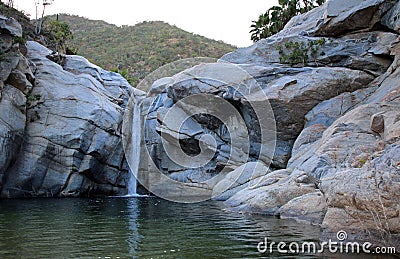 Waterfall and natural swimming pool at Cascada Sol Del Mayo on the Baja California peninsula in Mexico Stock Photo