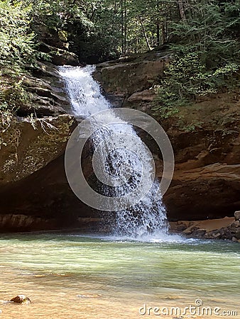 Waterfall next to rock outcroppings Stock Photo