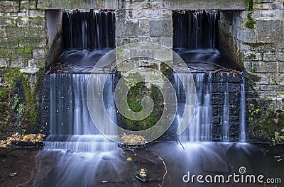 The waterfall out dam of city pond in Bueckeburg, Germany Stock Photo