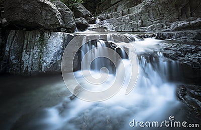 Waterfall over sliver rock Stock Photo