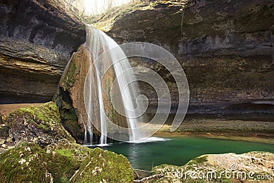 Waterfall in a rock cavity Stock Photo