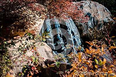 Waterfall shot through the fall foliage Stock Photo