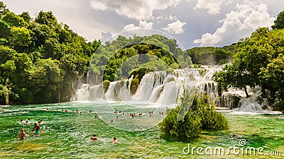 Waterfalls of Croatia.Tourists swimming near waterfalls in crystal clear water. Tourist spot in Dalmatia Krka National Park, place Editorial Stock Photo