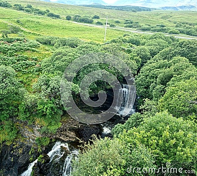 Waterfalls and green trees in Scotland Stock Photo