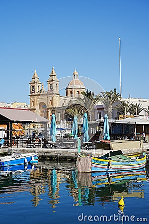 Waterfront in european Marsaxlokk town in Malta - vertical Editorial Stock Photo