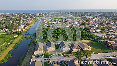 Waterfront Lake Pontchartrain neighborhood with row of townhomes, two-story single-family house, apartment complex along Farrar Stock Photo