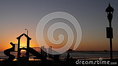 Waterfront playground. Children play, sunset ocean beach. Beachfront recreation area. California USA Editorial Stock Photo