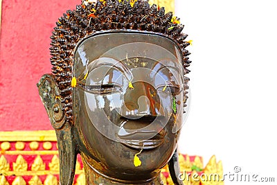 Watering Buddha statues with scented water and flower petals during Lao New Year - Pii Mai Lao - Song Kran - Water Festival in Apr Stock Photo