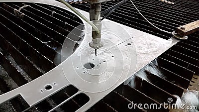 CNC Waterjet cuts stainless steel sheet - closeup Stock Photo