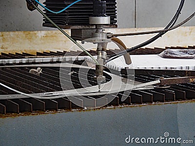 Waterjet cuts stainless steel sheet Stock Photo