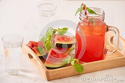 Watermelon drink in glass with slices of watermelon on whitebackground Stock Photo