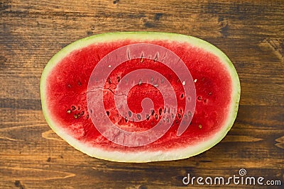 Watermelon half on rustic table Stock Photo