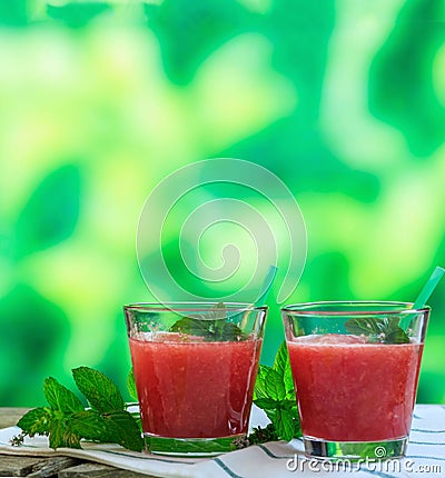 Watermelon juice glasses closeup view, blur green nature background Stock Photo