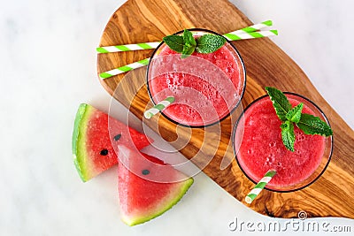 Watermelon juice on a wood serving board, overhead view on marble Stock Photo