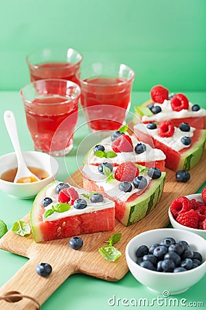 Watermelon pizza slices with yogurt and berries, summer dessert Stock Photo