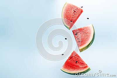 Watermelon slice falling on pastel background. Floating fruits in the air. Stock Photo