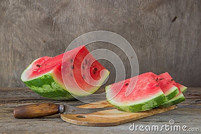 Watermelon slices on the woodan table. Fresh red watermelon. Rustical style. Stock Photo