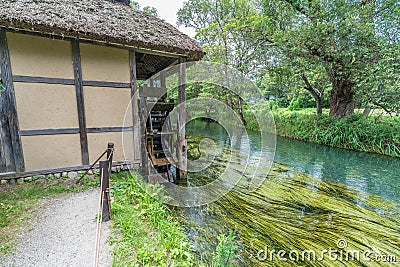 Watermill by Sai river (Sai-Gawa) near Daio Wasabi Farm in Azumino, Japan Editorial Stock Photo