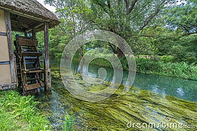 Watermill by Sai river (Sai-Gawa) near Daio Wasabi Farm in Azumino. Stock Photo