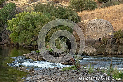 watermills from the guadiana in MÃ©rtola, where you can see a small waterfall due to the current of the river. Stock Photo
