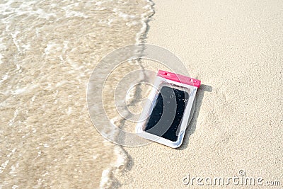 Waterproof case on a smartphone, phone for taking pictures under water. Phone in the waterproof case underwater, on the sands Stock Photo