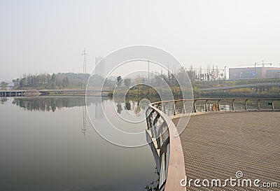 Waterside fenced and planked platform in sunny foggy winter Stock Photo