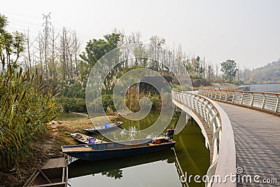 Waterside sanitation boasts under footbridge in sunny winter aft Stock Photo