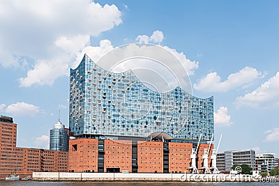 Waterside view of Elbphilharmonie concert hall with Elbe River against blue summer sky Editorial Stock Photo