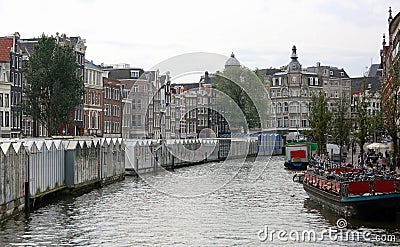 waterway in Amsterdam and houseboats with the flower market Stock Photo