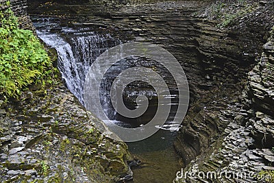 Cascading waters fill the rock made basin at the bottom of the gorge at Watkins Glen, NY State Park Stock Photo