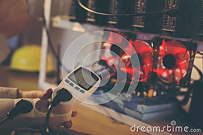 Wattmeter measuring mining rig energy consumption Stock Photo