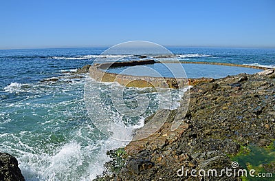 Wave action meets the rocky shoreline at Victoria Beach in Laguna Beach, California. Stock Photo