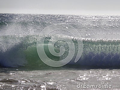 Wave breaking on the beach Stock Photo