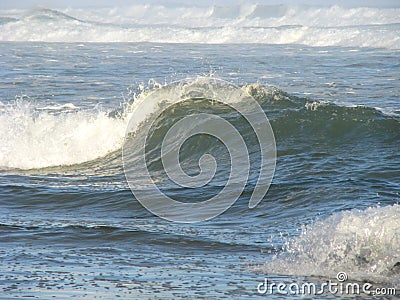 Wave crashing onto shore Stock Photo