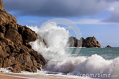 Wave Crashing on Rocks Cornwall England Stock Photo