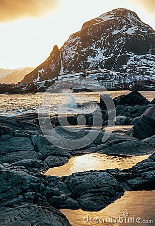 Wave hiting rocks at sunset Stock Photo