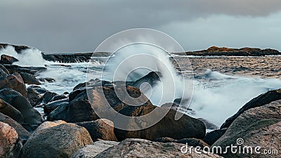 Wave hiting rocks at sunset Stock Photo