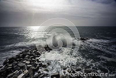 Wave hitting a waterblock in Italy - Riomaggiore Stock Photo