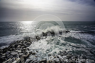 Wave hitting a waterblock in Italy - Riomaggiore Stock Photo