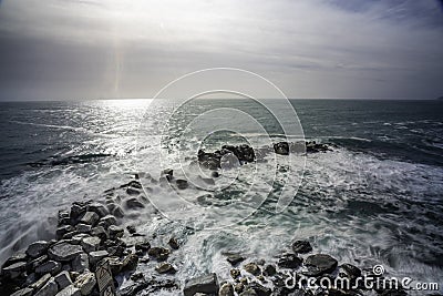 Wave hitting a waterblock in Italy - Riomaggiore Stock Photo