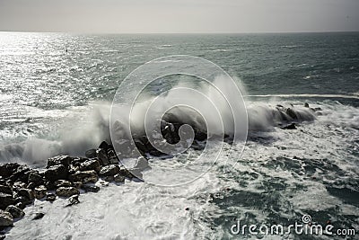 Wave hitting a waterblock in Italy - Riomaggiore Stock Photo