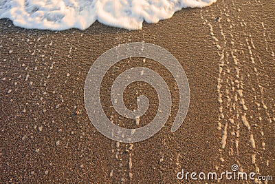 Wave moving on the sand. Tide of wave. Sea water drops and foam background Stock Photo