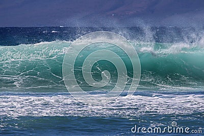 Wave at Rainbows on Maui. Stock Photo