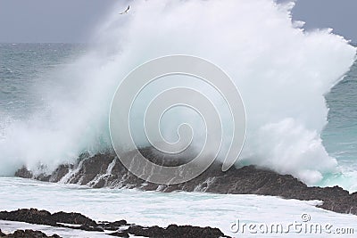 Wave slam against a rock Stock Photo